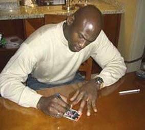 Upper Deck promotional photo of Jordan signing the 86-87 Fleer rookie cards for the 06-07 buyback auto release